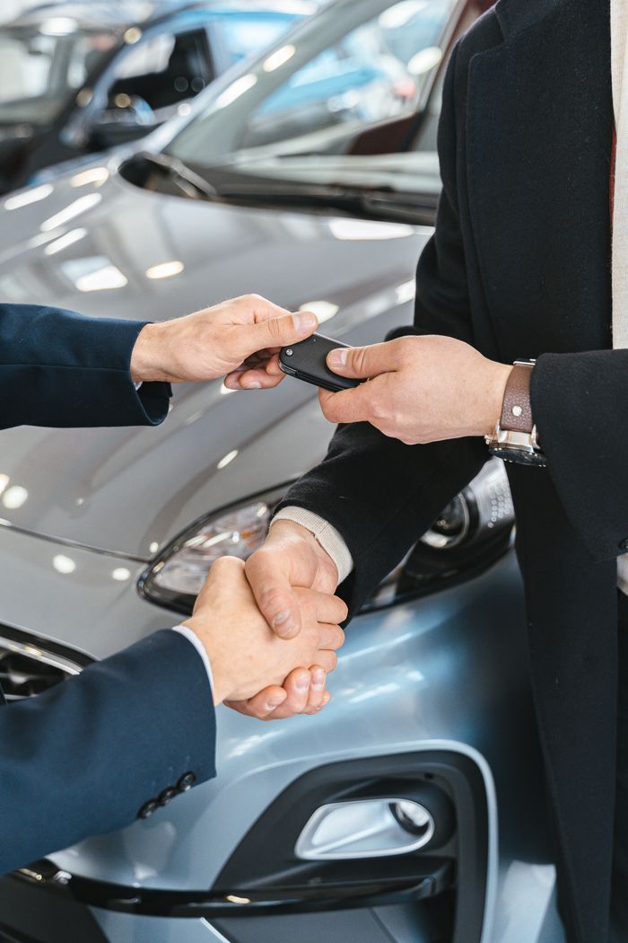 Crafting Captivating Headlines: Your awesome post title goes here Close-up of a business handshake as car keys are handed over, symbolizing a new car purchase.